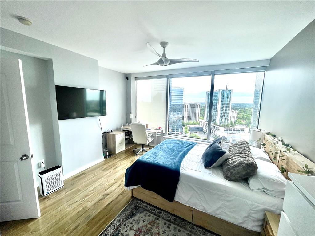 3338 Peachtree Road Northeast, Unit 2906 Atlanta, GA 30326 - Photo 15 of 27 a bedroom with a bed window and a flat screen tv