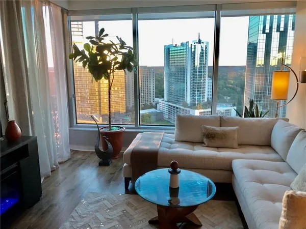 a living room with furniture and a chandelier