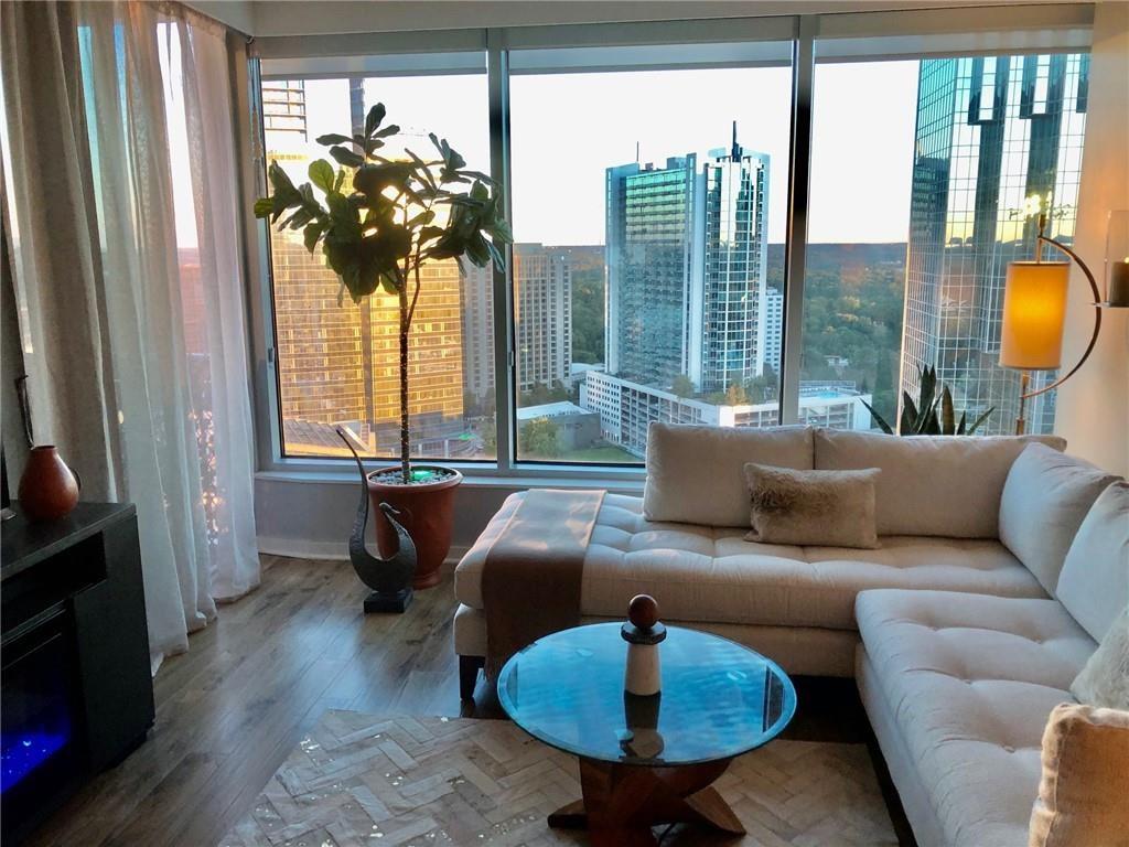 3338 Peachtree Road Northeast, Unit 2906 Atlanta, GA 30326 - Photo 2 of 27 a living room with furniture and a chandelier