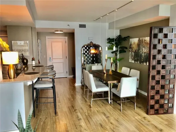 a dining room with furniture and wooden floor