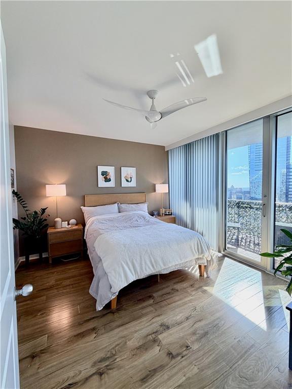 3338 Peachtree Road Northeast, Unit 2906 Atlanta, GA 30326 - Photo 10 of 27 a spacious bedroom with a bed windows and a table