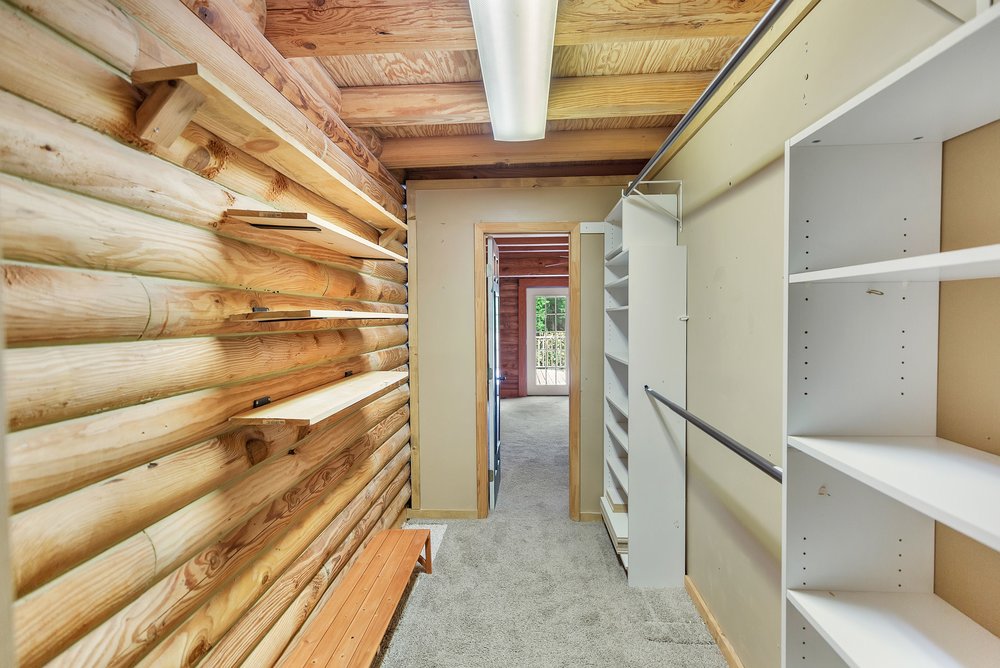 414 Devon Way Anderson, SC 29621 - Photo 20 of 50 A rustic wood-paneled walk-in closet offers ample storage and a direct view to a balcony.