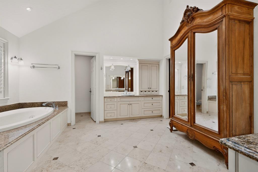 2405 Wing Point Lane Plano, TX 75093 - Photo 22 of 39 a bathroom with a tub a sink a mirror and a shower