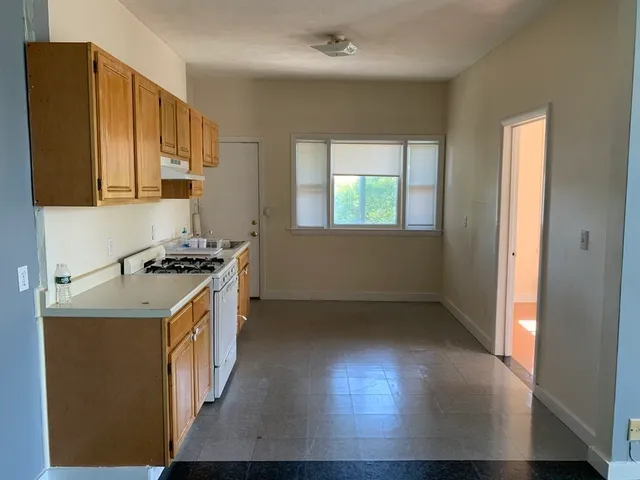 a kitchen with stainless steel appliances a stove a sink and a microwave