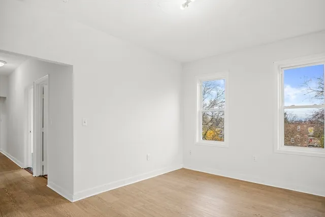 an empty room with windows and closet