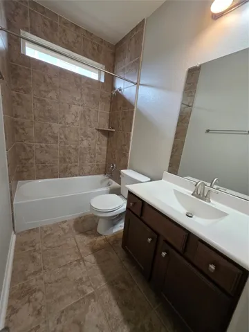 a bathroom with a double vanity sink toilet and shower