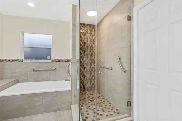a bathroom with a granite countertop shower