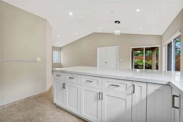 a kitchen with white cabinets