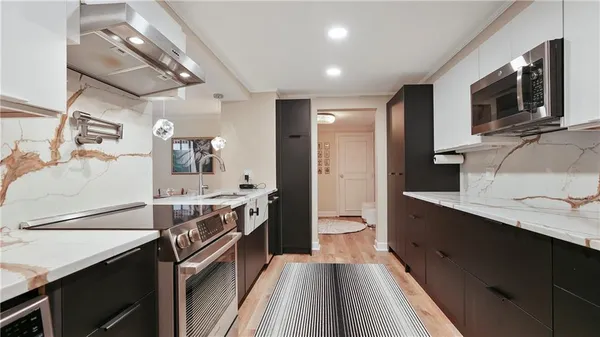 a kitchen with a sink stove and microwave