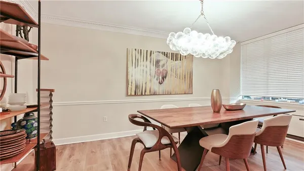 a view of a dining room with furniture window and wooden floor