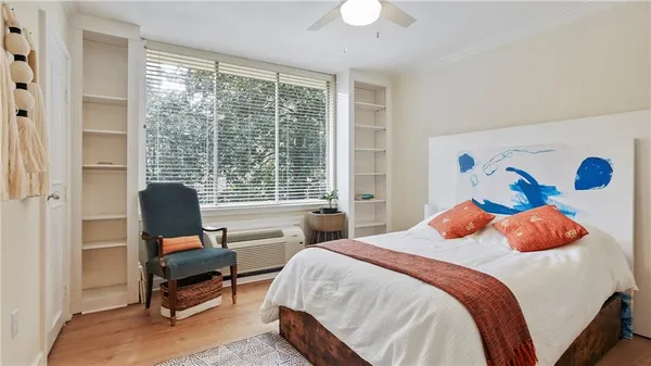 a bedroom with a bed and a large window