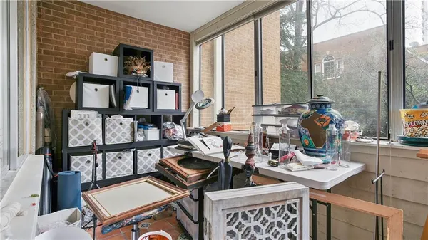 a living room with furniture and floor to ceiling windows