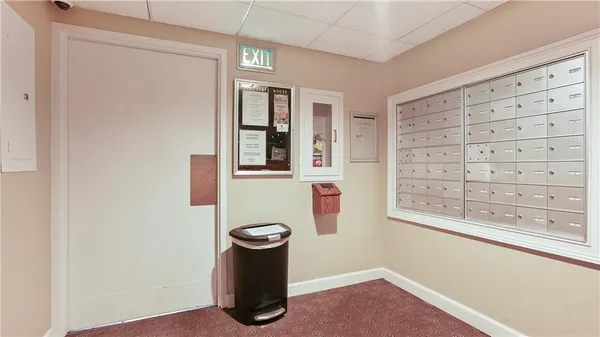 a view of empty room with windows and wardrobe