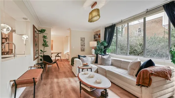 a living room with furniture and floor to ceiling windows
