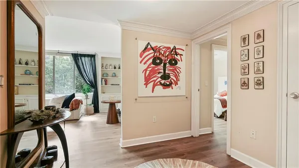 a view of a livingroom with furniture and hardwood floor