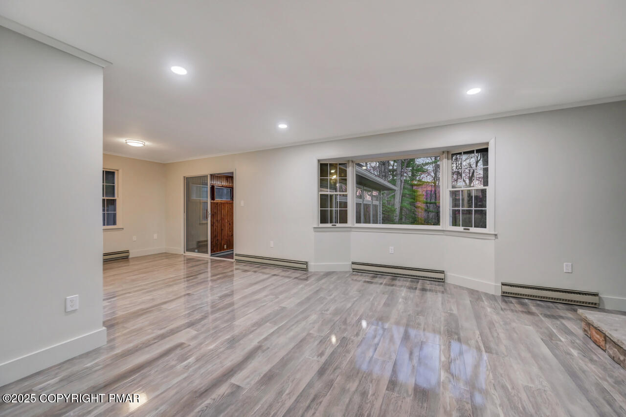 384 Devils Hole Road Cresco, PA 18326 - Photo 11 of 97 a view of an empty room with wooden floor and a window