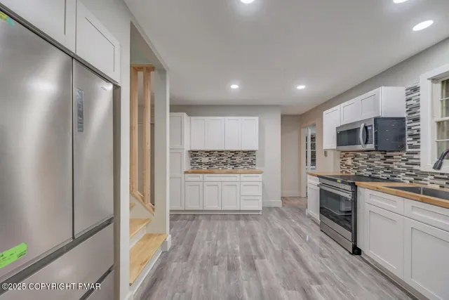 a view of empty room with wooden floor and fireplace