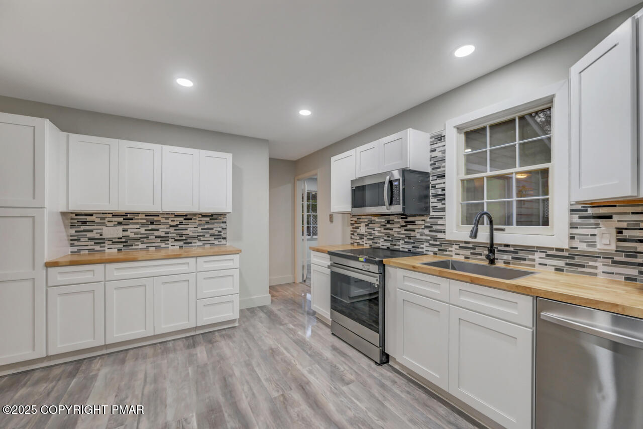 384 Devils Hole Road Cresco, PA 18326 - Photo 16 of 97 a kitchen with stainless steel appliances granite countertop a stove a sink and a refrigerator
