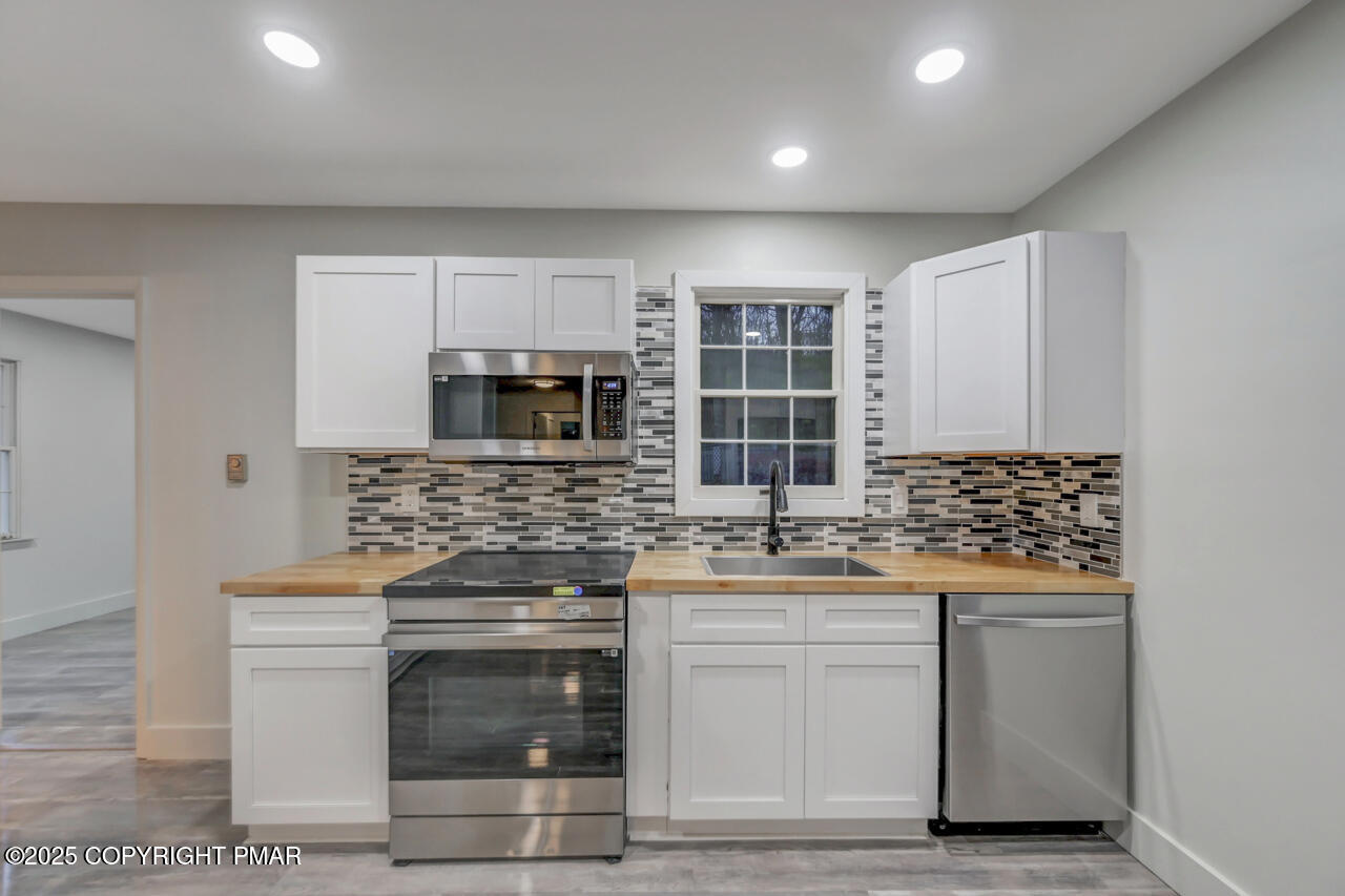 384 Devils Hole Road Cresco, PA 18326 - Photo 17 of 97 a kitchen with stainless steel appliances granite countertop a stove and a microwave