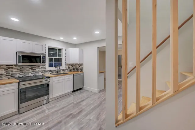 a bathroom with a toilet sink a mirror and shower