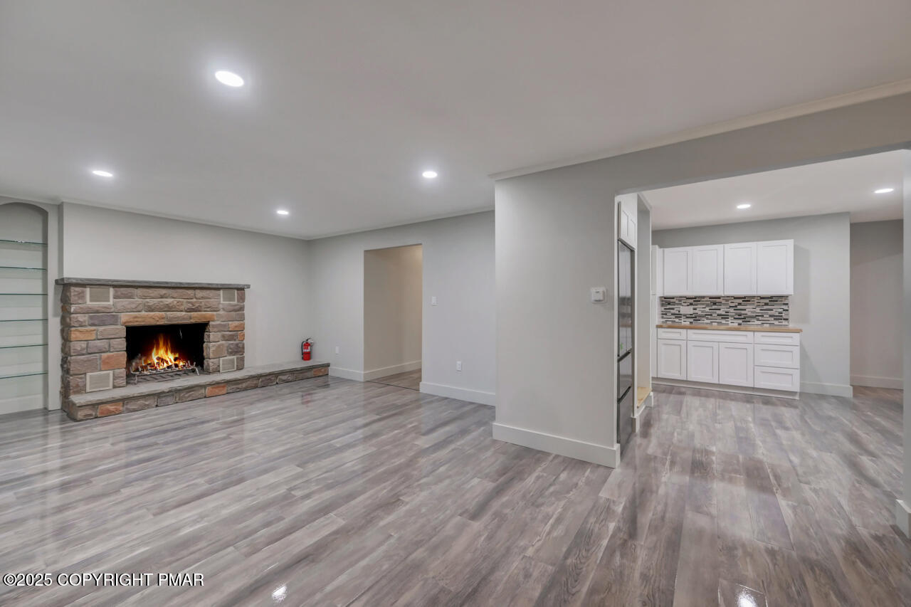 384 Devils Hole Road Cresco, PA 18326 - Photo 25 of 97 a view of empty room with wooden floor and fireplace