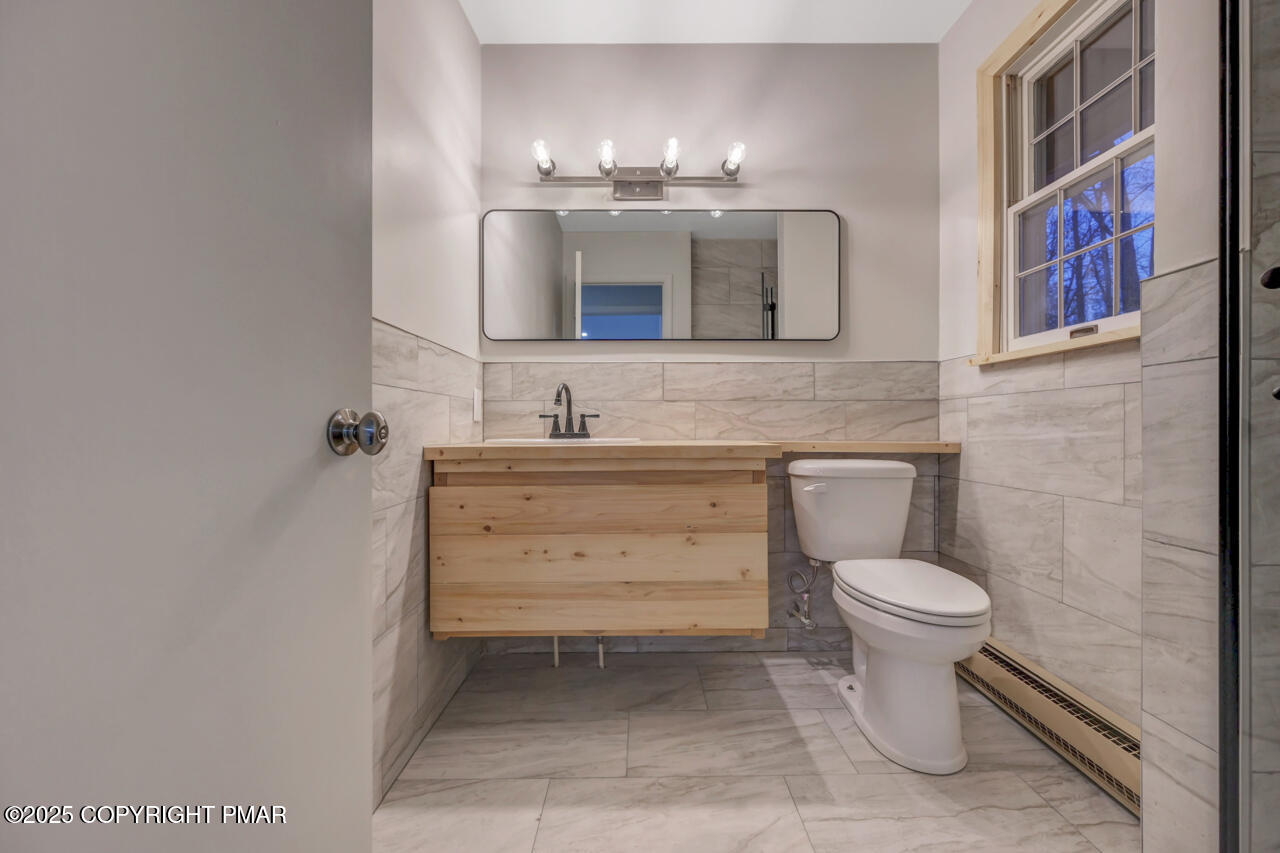 384 Devils Hole Road Cresco, PA 18326 - Photo 33 of 97 a bathroom with a toilet sink and mirror