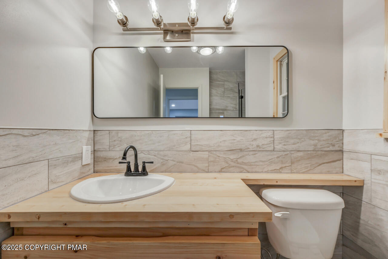384 Devils Hole Road Cresco, PA 18326 - Photo 35 of 97 a bathroom with a toilet a sink and mirror