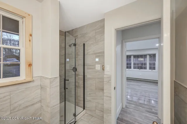 a view of empty room with wooden floor