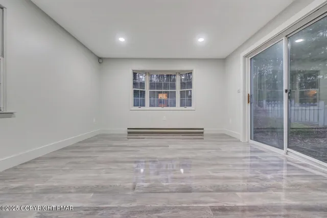 wooden floor in an empty room with a window