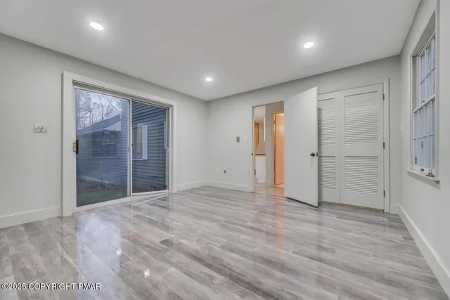 a bathroom with a tub shower sink and mirror