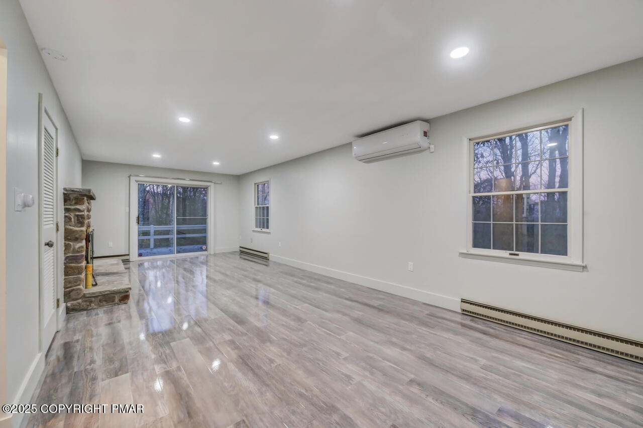 384 Devils Hole Road Cresco, PA 18326 - Photo 43 of 97 an empty room with wooden floor and windows