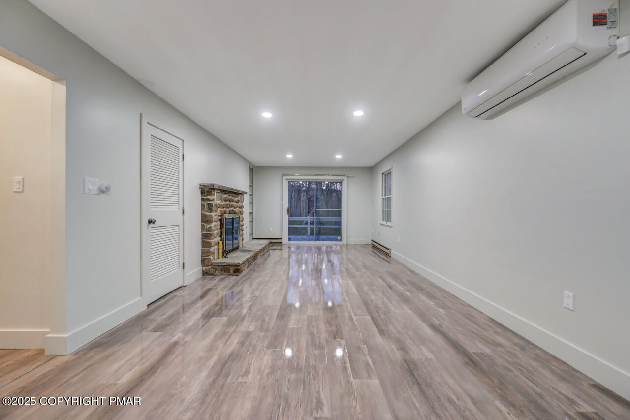 384 Devils Hole Road Cresco, PA 18326 - Photo 44 of 97 a view of empty room with wooden floor and window