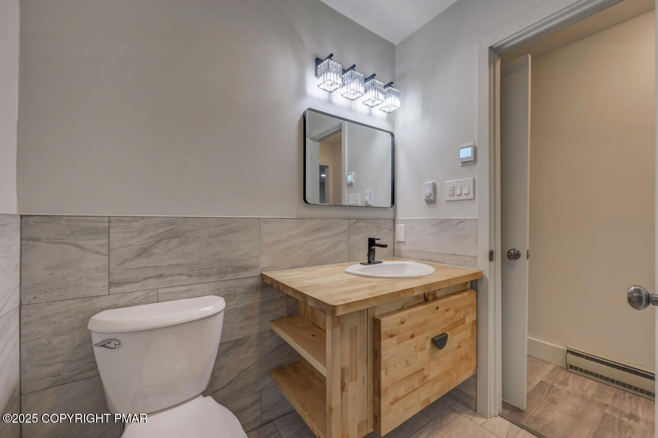 384 Devils Hole Road Cresco, PA 18326 - Photo 50 of 97 a bathroom with a toilet sink and mirror