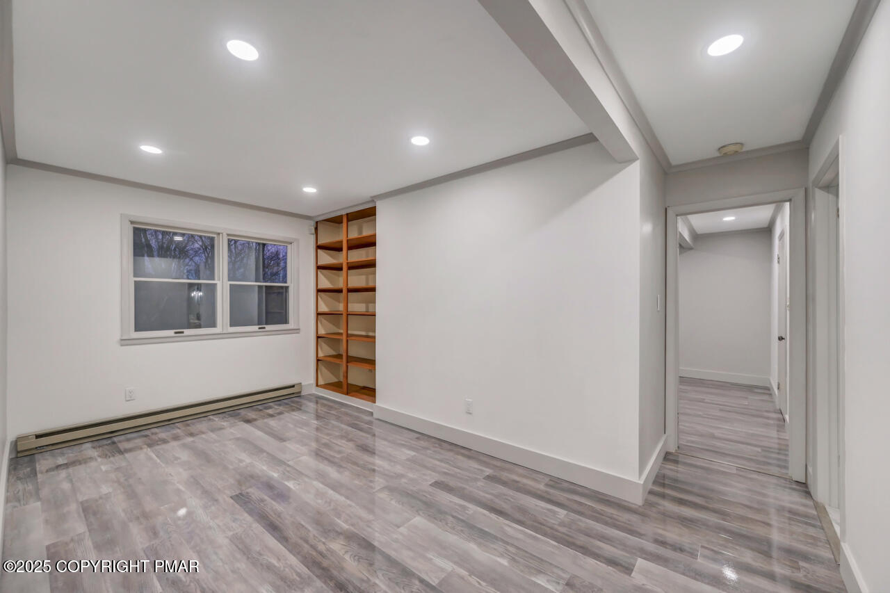 384 Devils Hole Road Cresco, PA 18326 - Photo 53 of 97 a view of an empty room with wooden floor and a window