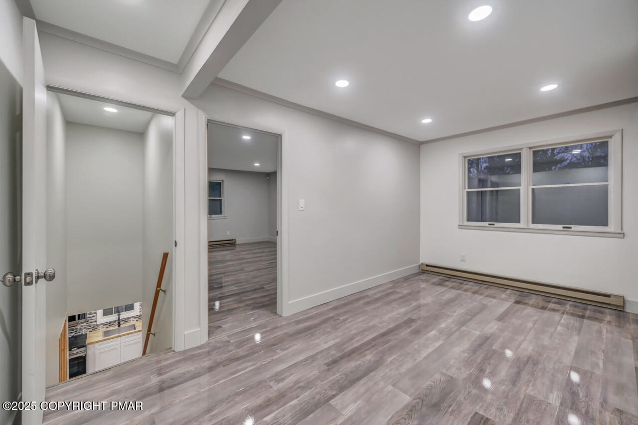 384 Devils Hole Road Cresco, PA 18326 - Photo 55 of 97 a view of empty room with wooden floor and fan