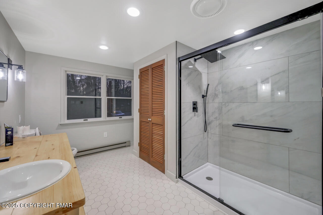 384 Devils Hole Road Cresco, PA 18326 - Photo 63 of 97 a bathroom with a tub shower sink and mirror