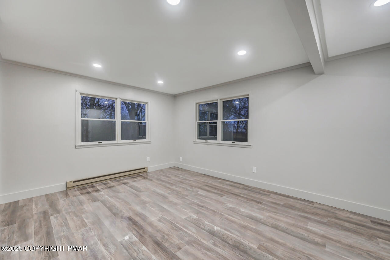 384 Devils Hole Road Cresco, PA 18326 - Photo 70 of 97 a view of empty room with wooden floor and fan