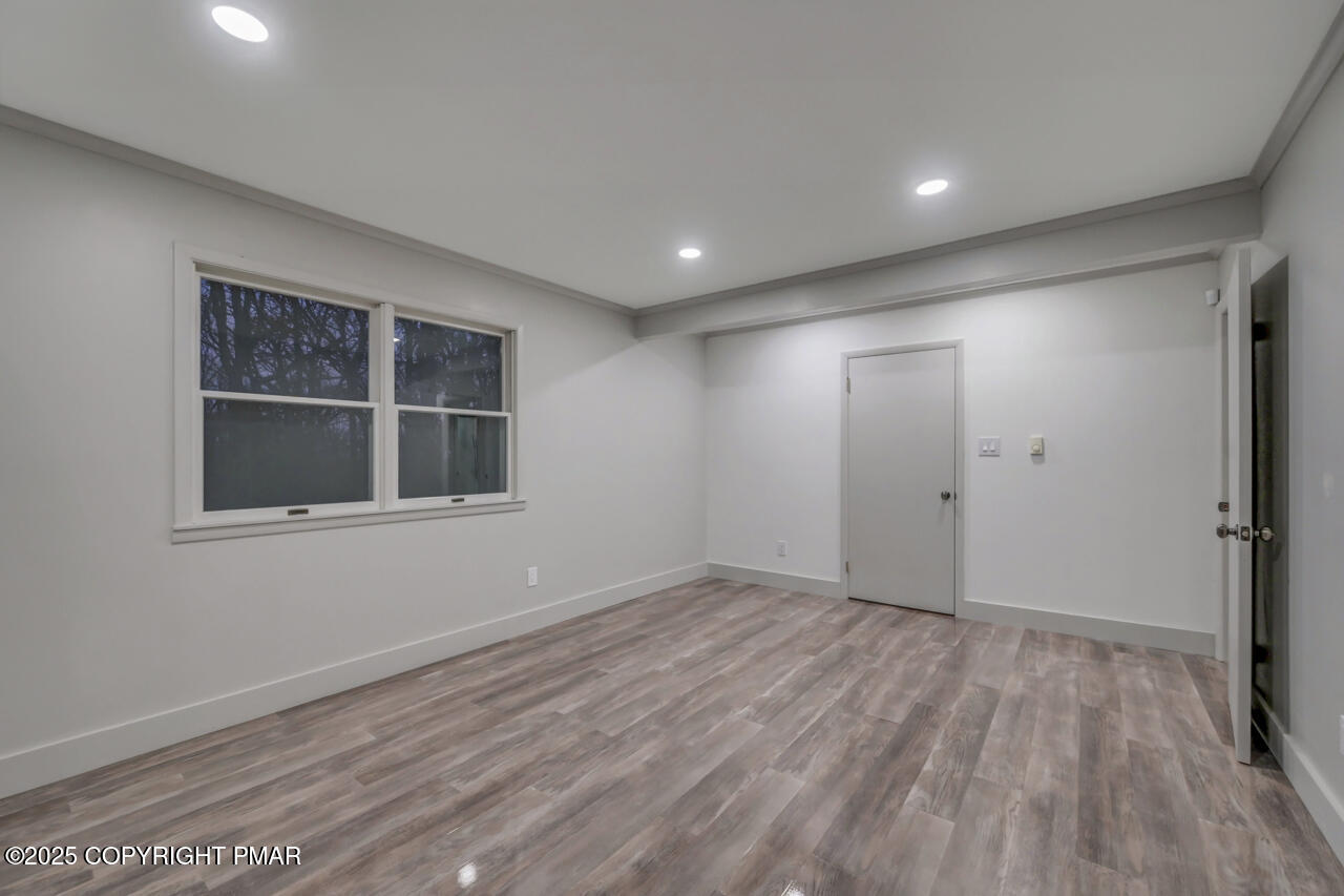 384 Devils Hole Road Cresco, PA 18326 - Photo 71 of 97 a view of empty room with wooden floor and fan