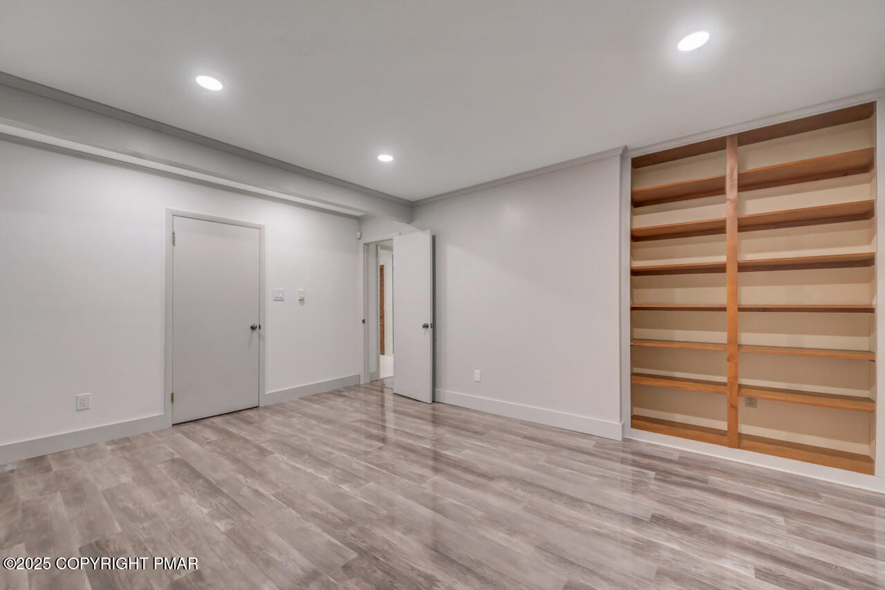 384 Devils Hole Road Cresco, PA 18326 - Photo 72 of 97 a view of an empty room with a wooden floor and a window