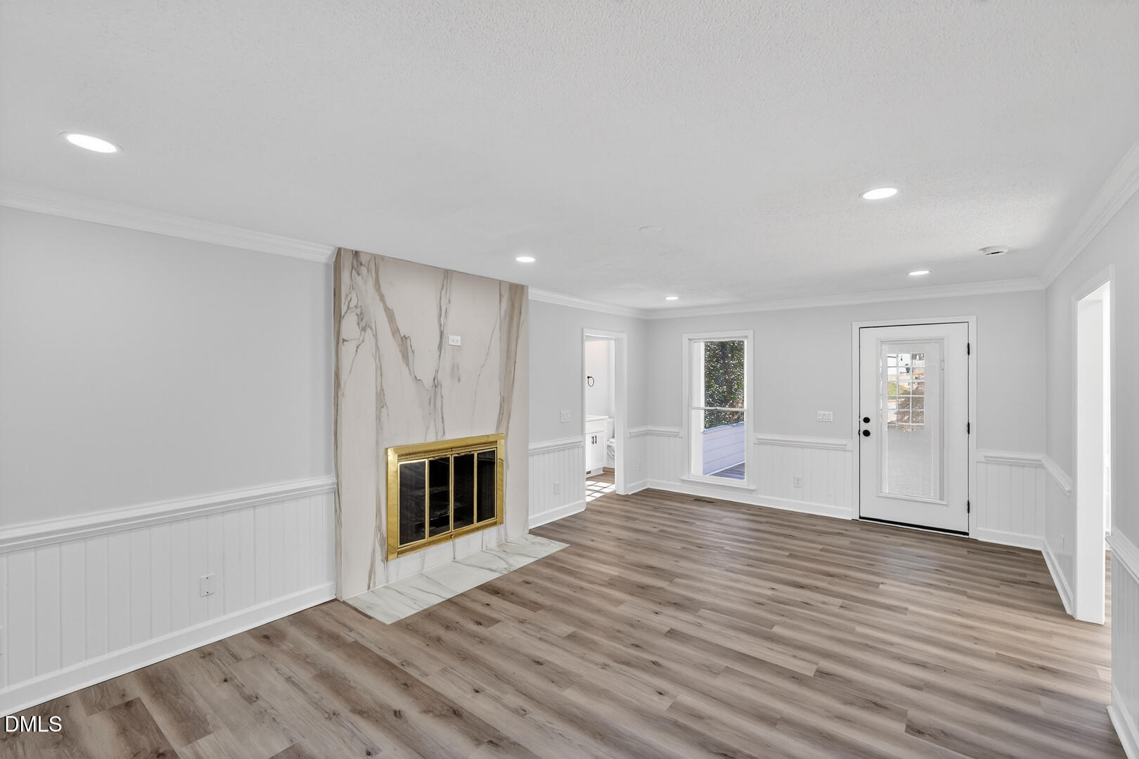 2224 Effingham Circle Raleigh, NC 27615 - Photo 14 of 51 a view of an empty room with wooden floor fireplace and a window