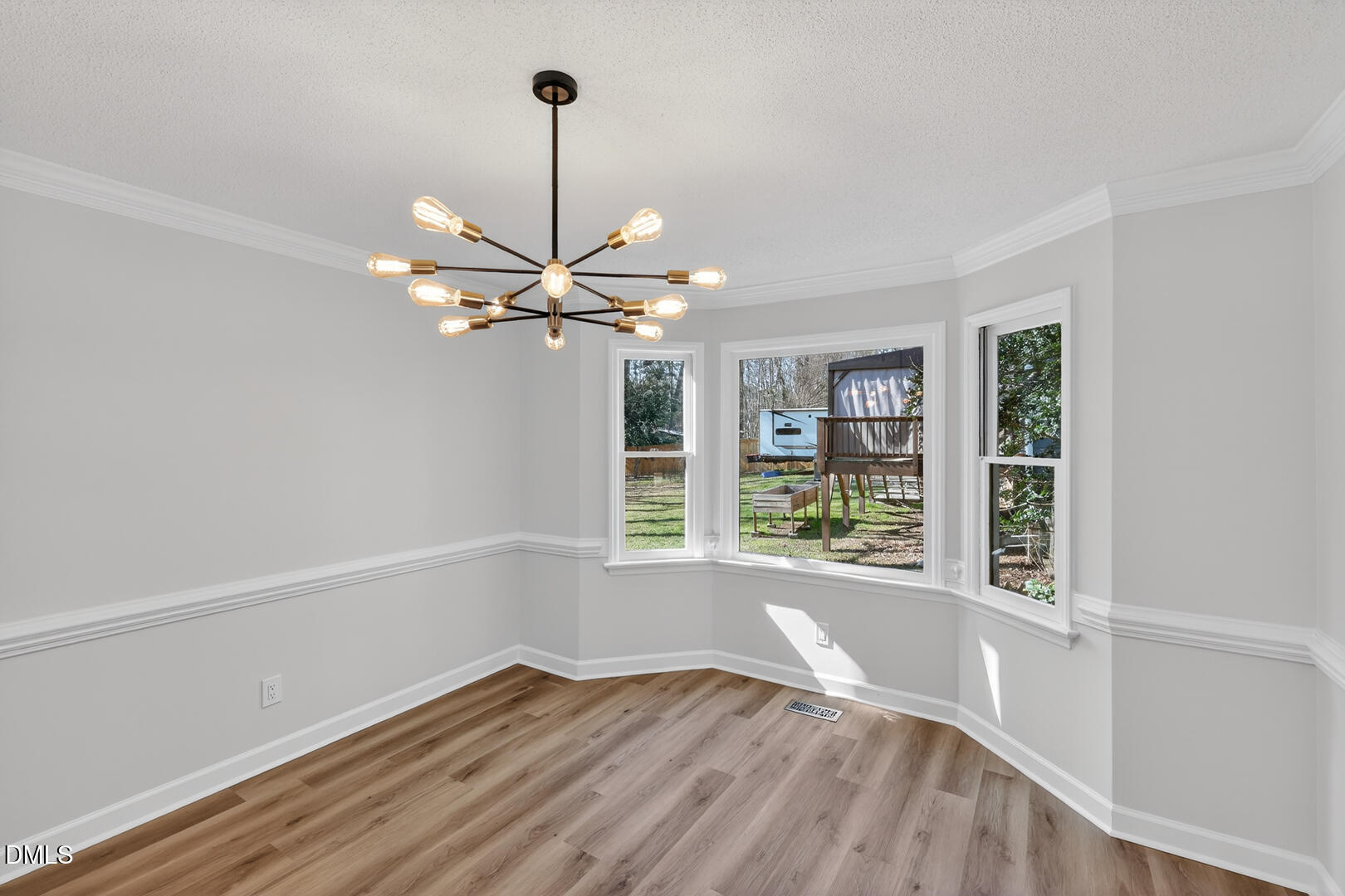 2224 Effingham Circle Raleigh, NC 27615 - Photo 22 of 51 a view of an empty room with a window and wooden floor