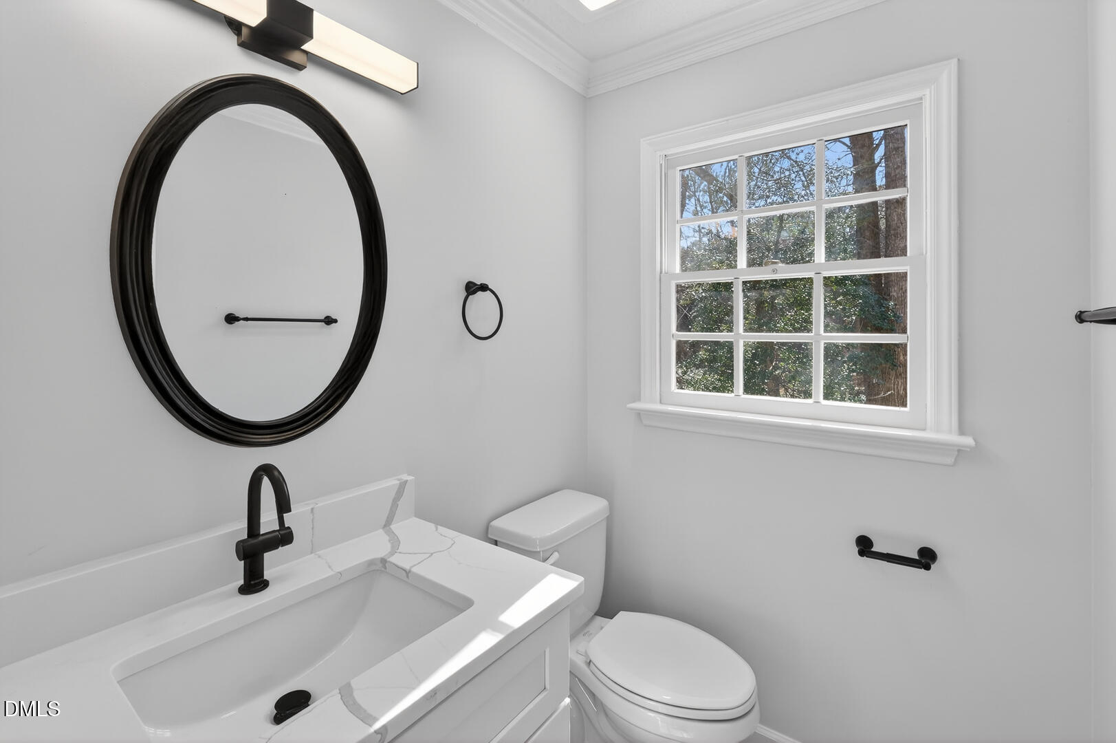 2224 Effingham Circle Raleigh, NC 27615 - Photo 24 of 51 a bathroom with a sink a toilet and a mirror