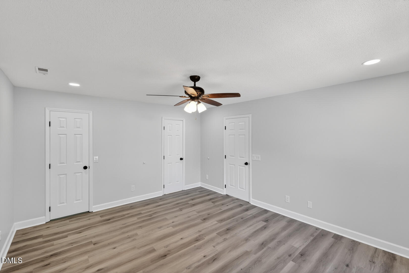 2224 Effingham Circle Raleigh, NC 27615 - Photo 41 of 51 a view of a room with wooden floor and a ceiling fan
