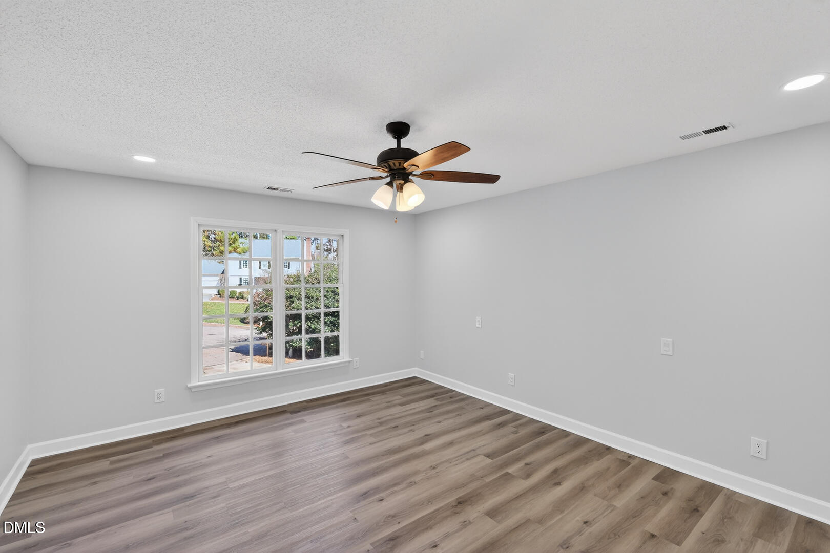 2224 Effingham Circle Raleigh, NC 27615 - Photo 43 of 51 a view of empty room with wooden floor and fan