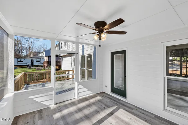 a view of a livingroom with a ceiling fan and window