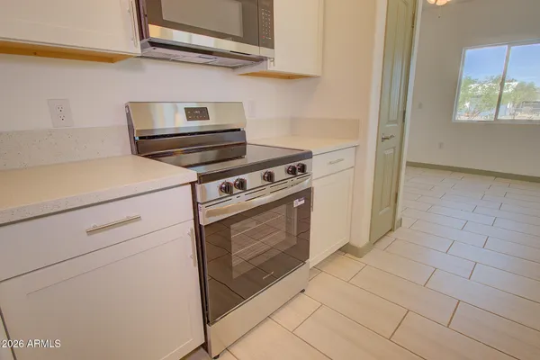 a kitchen with cabinets and a stove top oven