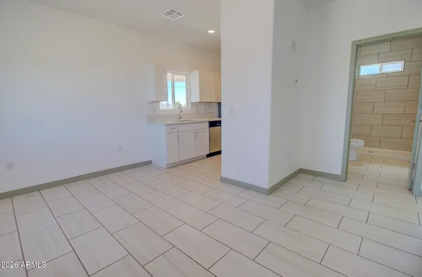 a view of a kitchen with white cabinets