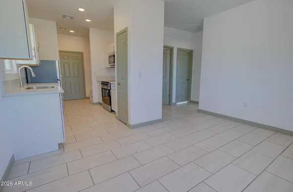 a view of a kitchen with refrigerator and sink