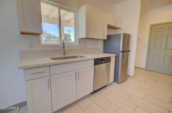 a kitchen with white cabinets and a sink