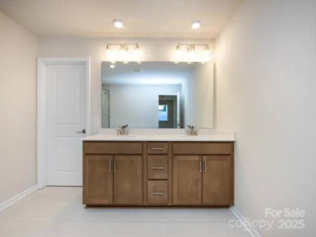 a bathroom with a double vanity sink and a mirror